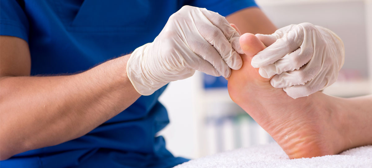 photo of podiatrist treating someone’s bare feet